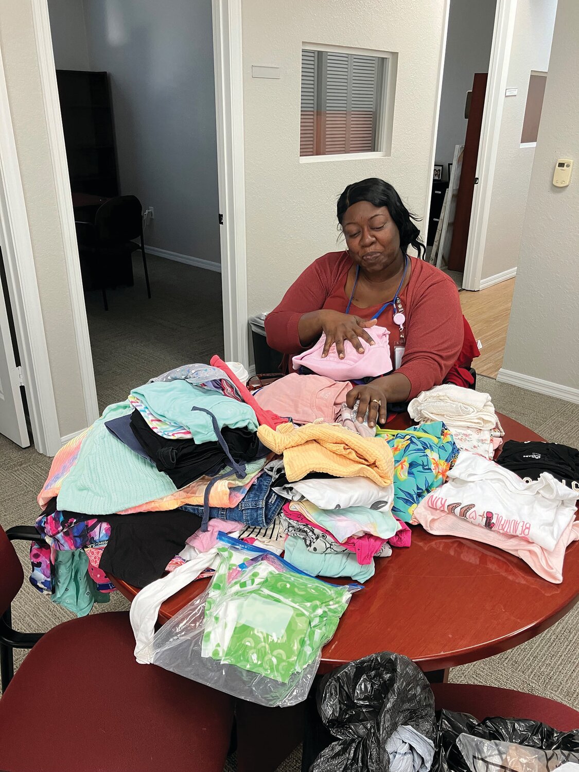 Farrah Wittaker sorts clothes donated to CCKids.